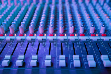 Obraz premium View of music mixer in concert, filled with blue lights