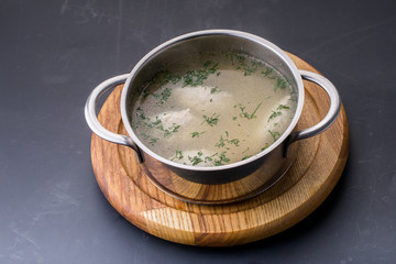 close-up of Chicken bouillon, broth, clear soup in a bowl with m