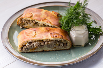 Cooked meat pie pieces with souce
