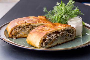 Savoury meat pie with a beef filling on a rustic plate