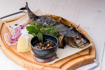 fried fish with fresh herbs and lemon