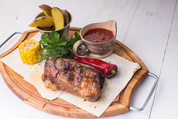 Assorted delicious grilled meat with vegetable over wooden plate