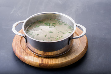Chicken bouillon, broth, clear soup in a bowl with meat pieces o