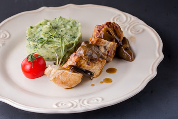 chicken meat with mashed potatoes over white table