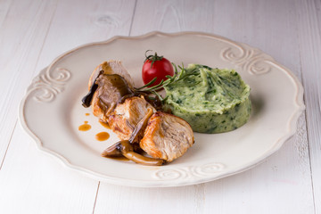 chicken meat with mashed potatoes over white table