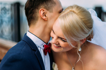 Bride and groom at wedding Day hugging Outdoors on spring nature