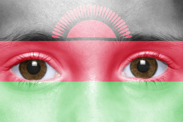 human's face with malawi flag