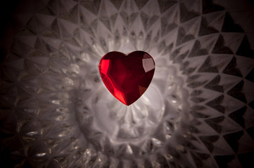 Red heart on a dark and geometrical crystal background