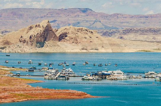 Sunny day at Lake Powell with many boats and canyon in the background - Powered by Adobe