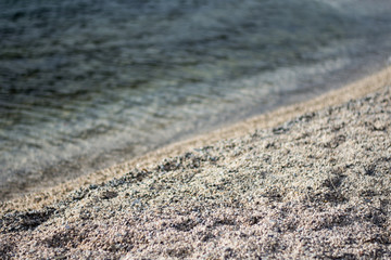 Stone beach with sea waves in the background