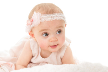 Horizontal shot of adorable baby girl looking away shot against white background with copy paste