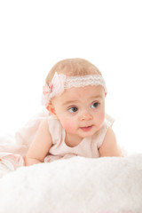 Vertical shot of adorable baby girl looking away shot against white background with copy paste