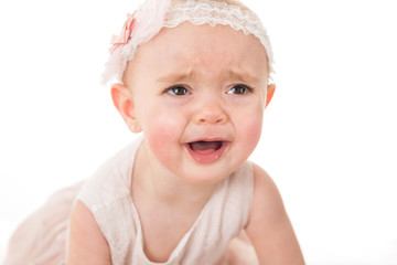 Portrait of sad little girl crying for her toy shot against white background