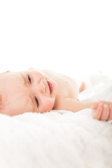 Portrait of tired young girl lying on the bed shot against white background with copy space