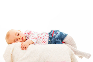 Portrait of modern dressed child falling asleep on improvised bed shot against white background with copy paste