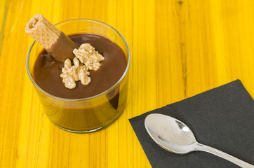 Fresh chocolate mousse with walnut and mint.