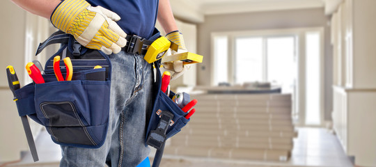 Builder handyman with construction tools.