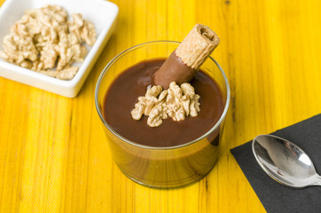 Fresh chocolate mousse with walnut and mint.