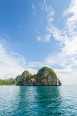 Thailand tropical island cliffs over ocean water during tourist boat trip in Railay Beach resort