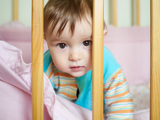 Little baby in a cot.