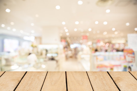 Empty top wooden table and supermarket blur background
