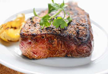 steak on a plate with greens
