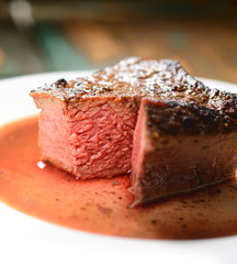 steak on a plate with greens
