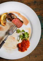 steak on a plate with greens
