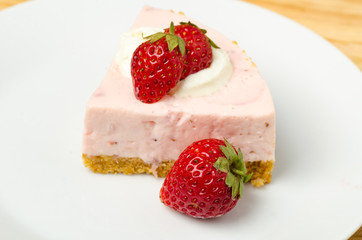 Homemade strawberry cheesecake  on white plate