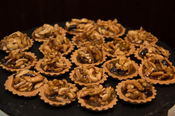Piece of nut pie tart with various nuts
