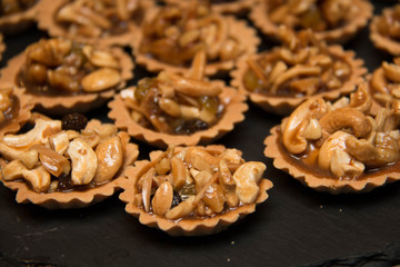 Piece of nut pie tart with various nuts