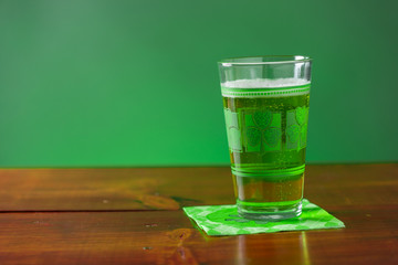 St. Patricks Day cold glass of green beer on a wood background