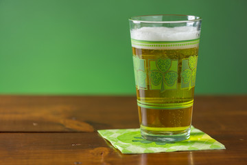St. Patricks Day cold glass of beer on a wood background