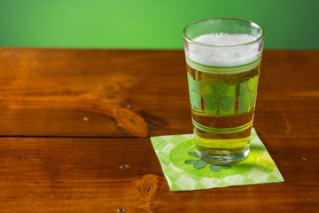 St. Patricks Day cold glass of beer on a wood background