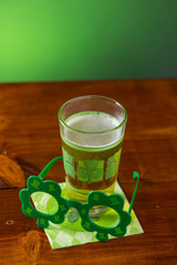 St. Patricks Day cold glass of beer on a wood background