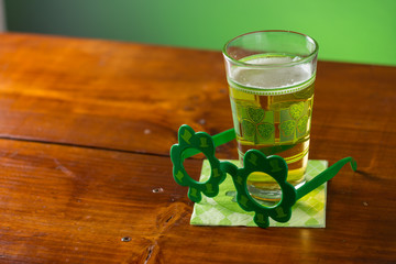 St. Patricks Day cold glass of beer on a wood background
