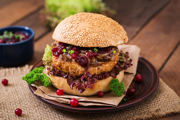 Hamburger with juicy turkey burger with cheese, caramelized onions and cranberry sauce