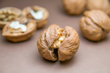 Cracked walnut on the background of other blurred walnuts