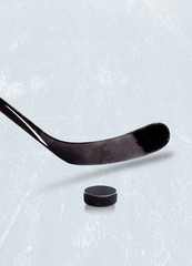 Ice hockey stick and puck on ice with copy space. - obrazy, fototapety, plakaty
