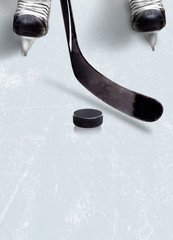 Fototapeta premium Ice hockey stick and puck on ice with copy space.
