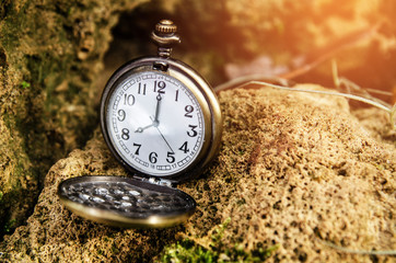 vintage pocket watch on stone