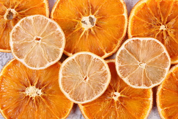 Slices of dried lemon and orange on old wooden background