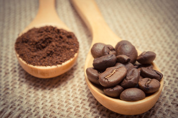 Vintage photo, Grains and ground coffee with wooden spoon on jute canvas