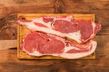 Raw fresh meat Rib eye  steak on wooden background