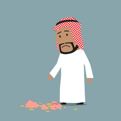 Arab businessman with broken piggy bank