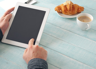 Men hand clicks on the tablet screen