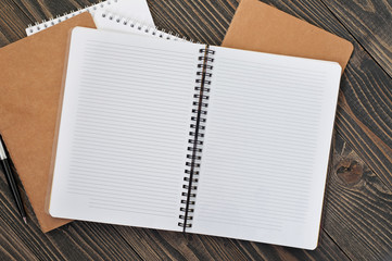 notepad with blank pages and pen