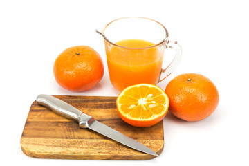 Fresh oranges and orange juice on white background