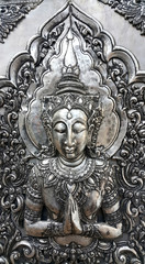 Embossed thai angle on silver plate in temple, Thailand