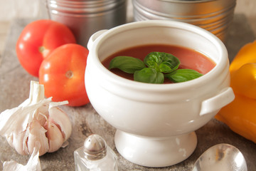 tomato soup with basil in white plate